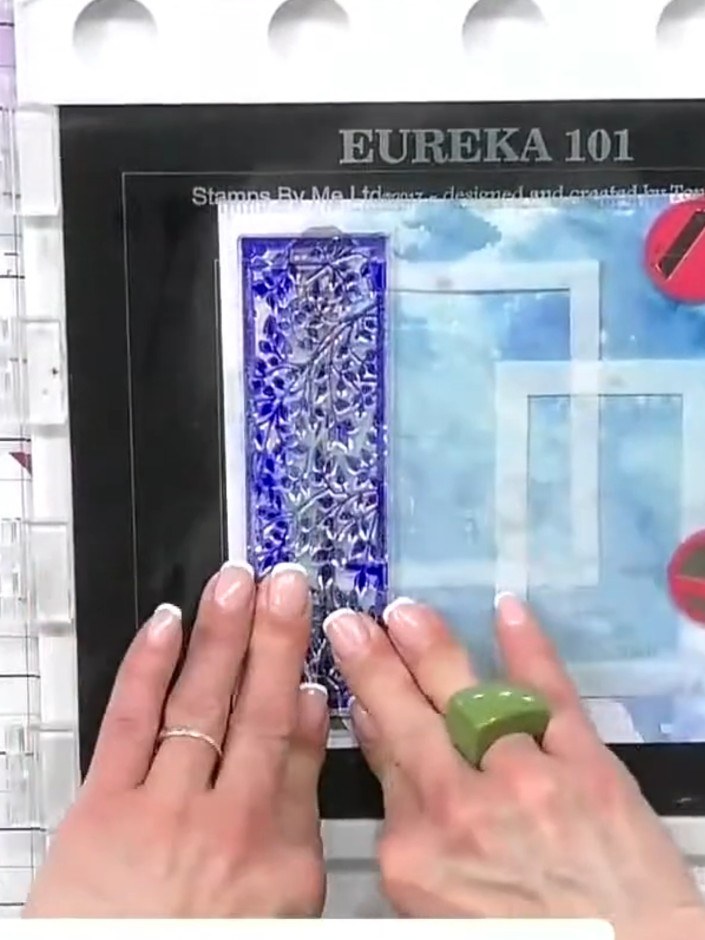 Step 2: Apply ocean blue ink over the apertures and lamp post mask using a blending tool. Stamp the decorative border 
