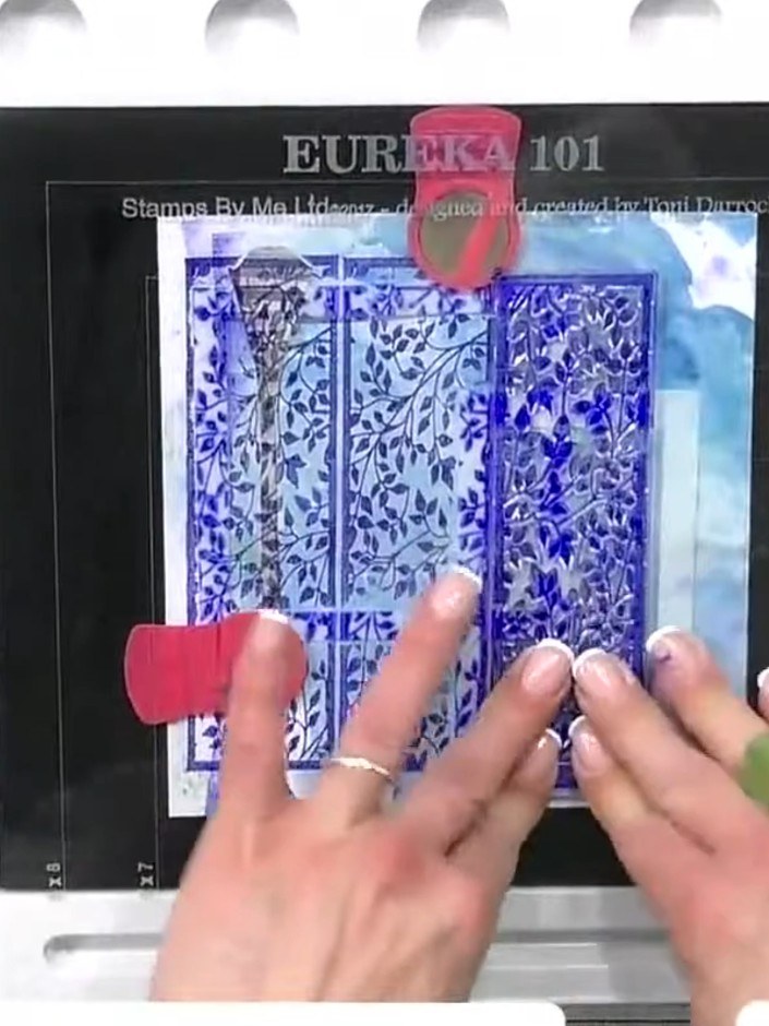 Step 4: Position your cut-out character onto the stamped background panel, layering her over the blue city elements to