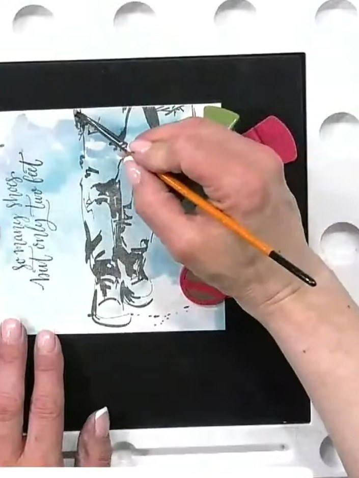 Step 4: Using a damp brush, pull the watercolour across the stamped image to create light and shadow effects. Build up