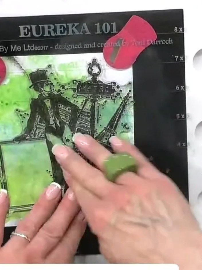 Step 2: Stamp the decorative panel image from the Eureka 101 stamp set onto the green watercolour background, position