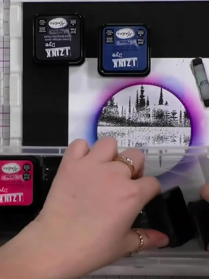 Step 4: Layer a dirty piece of card or stencil over the top of your stamped circular image to create a shadow effect. 