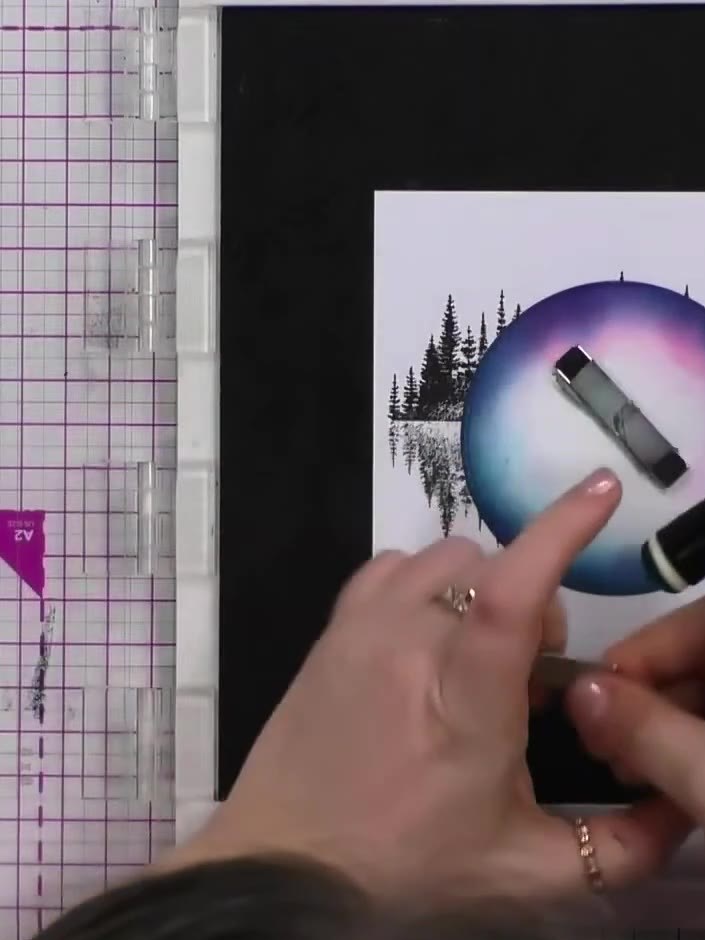 Step 5: Apply dark blue ink around the outside edges of the circular stencil to create a shadow effect around the land