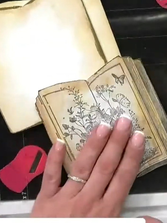 Step 3: Cut two pieces of plain cream card stock slightly larger than your painted book card. Trim around the book sha