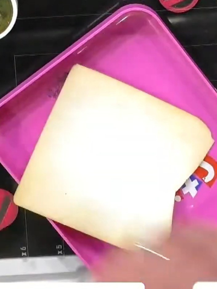 Step 5: Heat emboss the edges of the cream card using a heat tool to set the gold embossing powder and create a framed