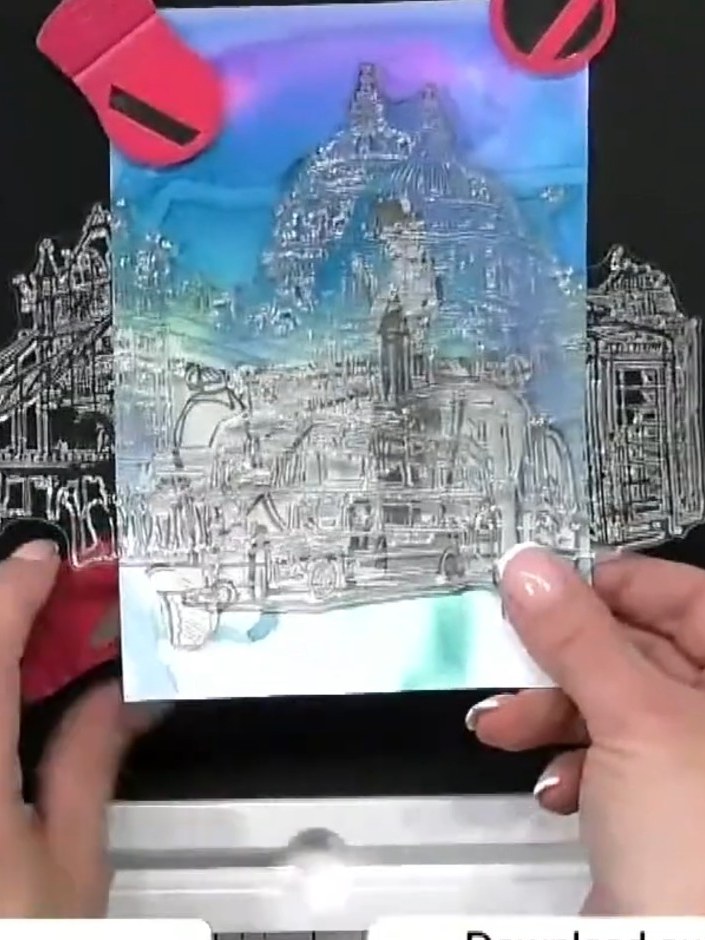 Step 4: Stamp the City Lights London scene stamp over the masked background using black ink. Ensure good coverage acro