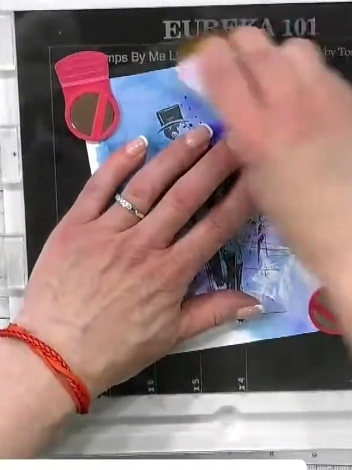 Step 3: Apply purple and blue watercolour inks around the stamped image using Imala watercolour brushes. Tap gently on