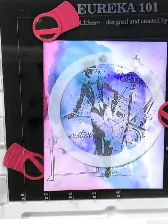 Step 6: Load a fan brush with watercolour ink and splatter confetti or additional colour around the design to add text