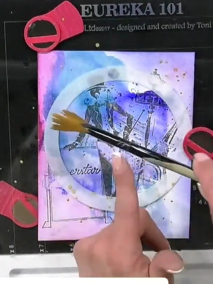 Step 7: Dip a wet brush into gold pearlescent ink and apply it around the edges of the hot air balloon design. Allow t