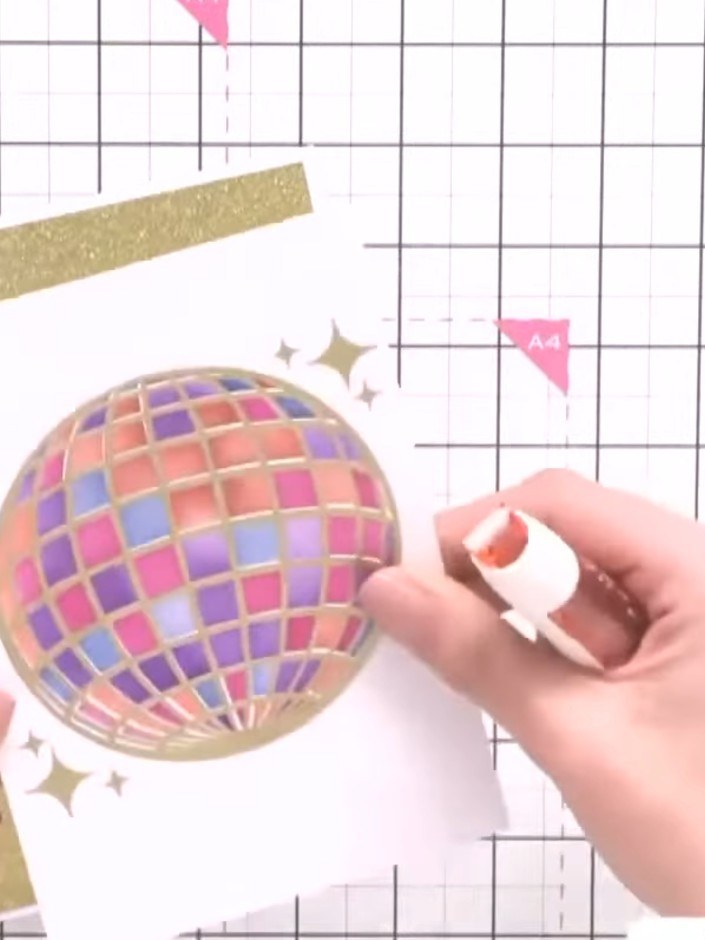 Step 6: Mount your completed disco ball topper onto your card base using foam pads to add dimension. Position it centr