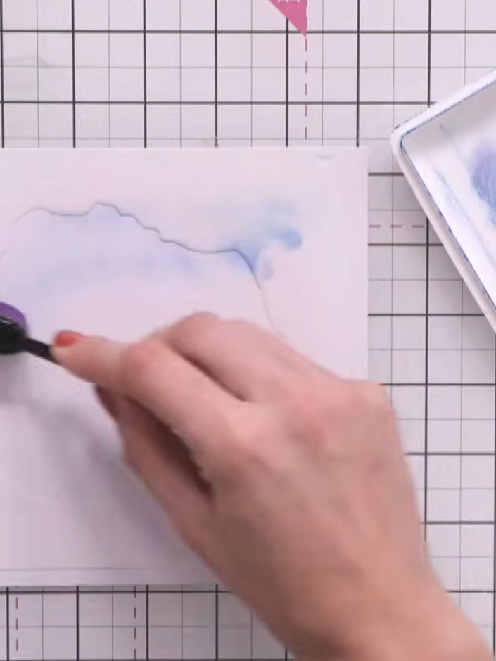Step 2: Using a blending brush, apply light blue ink loosely through the first layer of the Radiant Poppies stencil. W