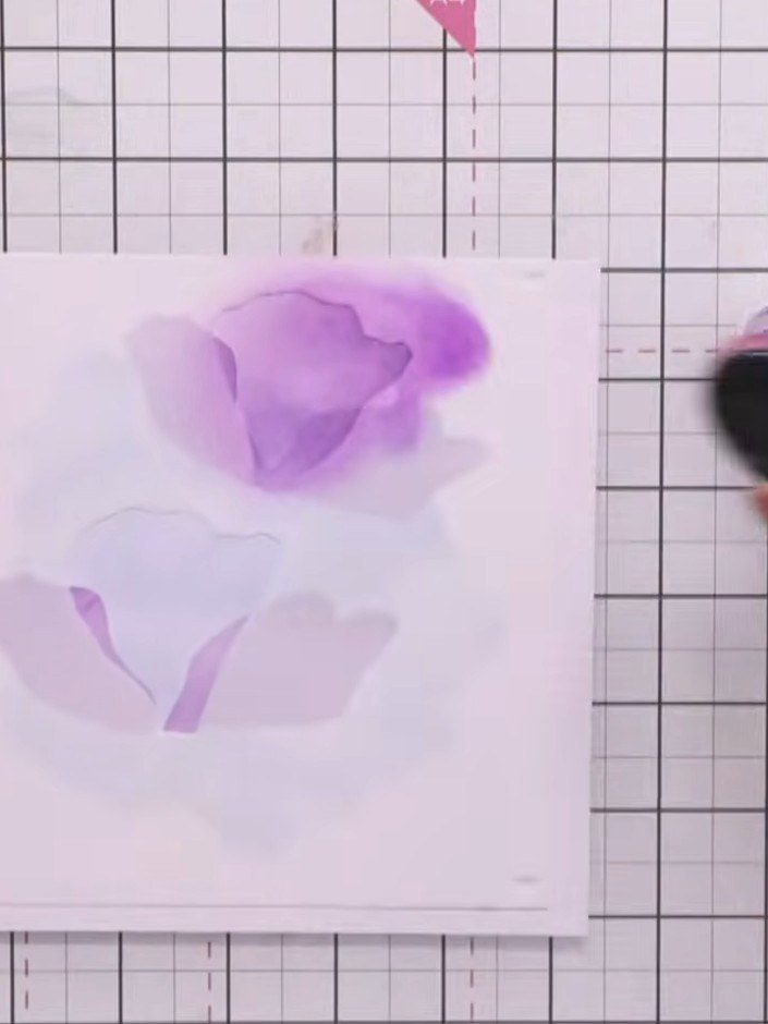Step 6: Move the splat stencil to different positions on your card and add more purple ink splats as desired to create