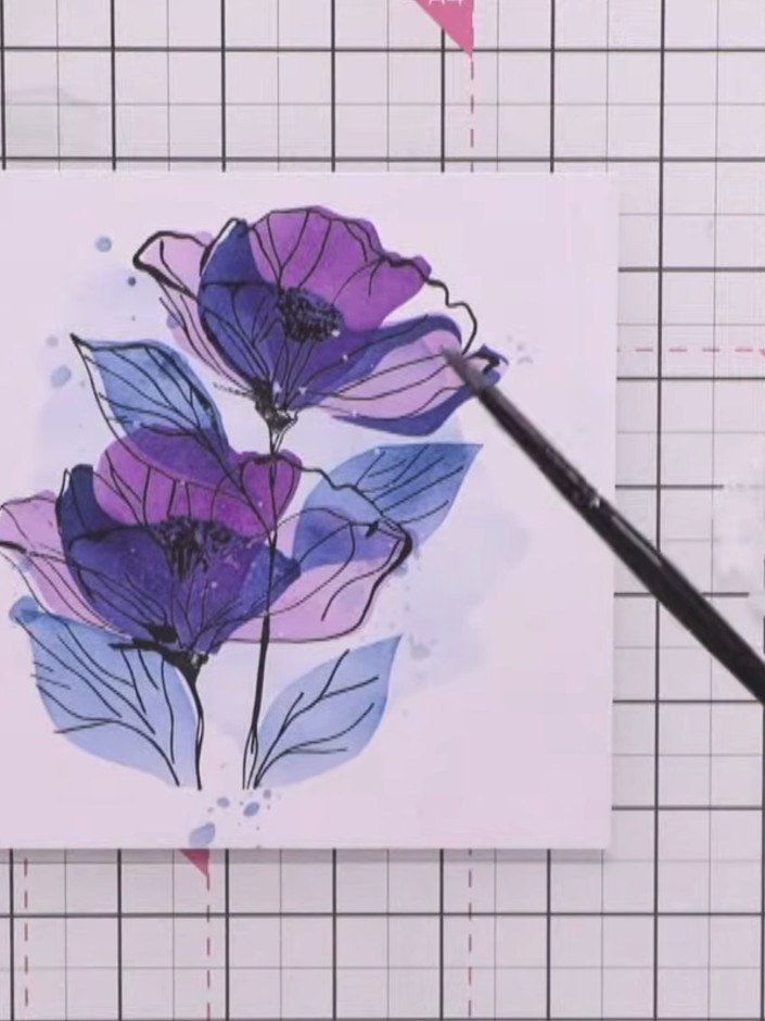 Step 8: Optional: Add white splats to the card for extra artistic detail. Spray white ink onto a paintbrush and flick 
