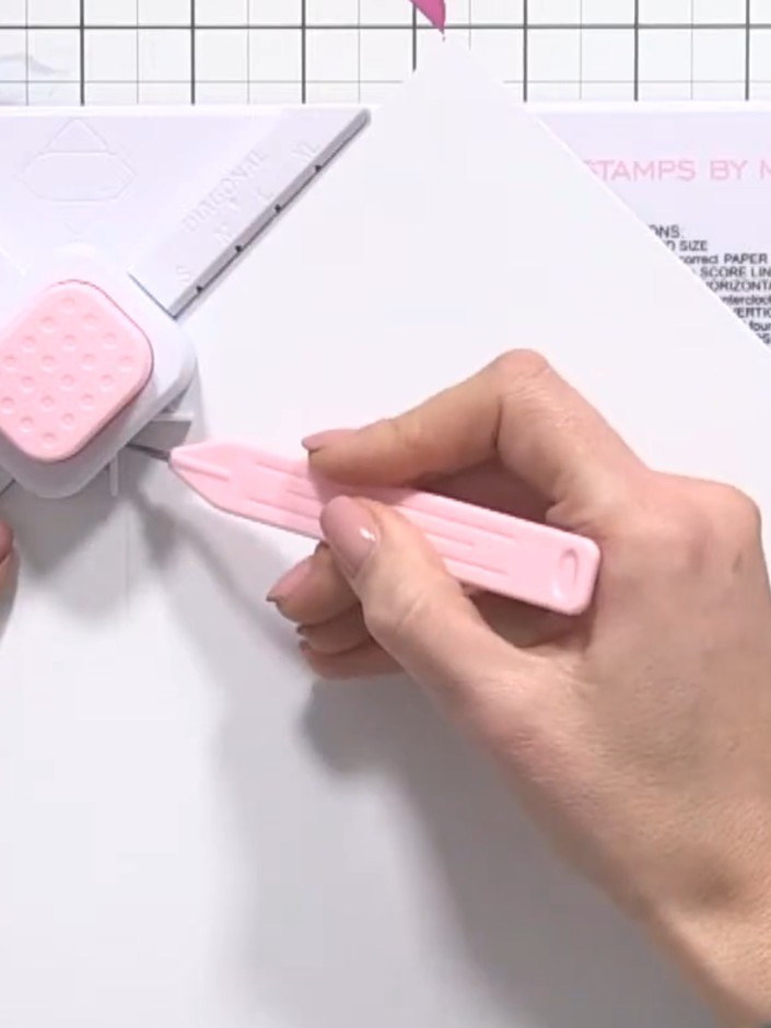 Step 4: Position the envelope board so the 4.5 inch score line is aligned with the corner punch guide. Punch the corne