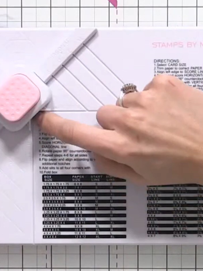 Step 7: Rotate the envelope board 90 degrees and align the card with the score line. Score across at this new position