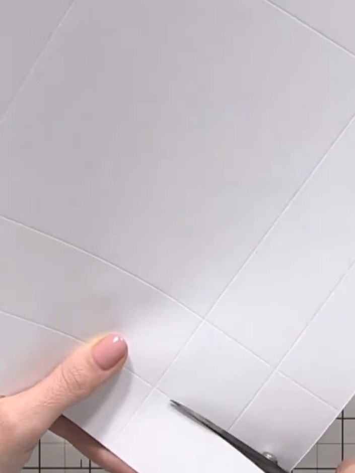 Step 10: Fold the sides of the base box inward and tuck the flaps underneath to create the base shape. Hold the card fi