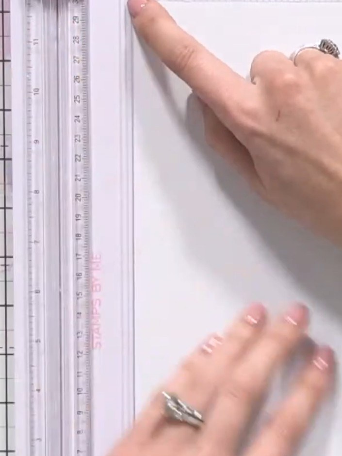 Step 5: Place the trimmed base paper on the scoreboard. Using the measurements marked on the scoreboard, score lines a