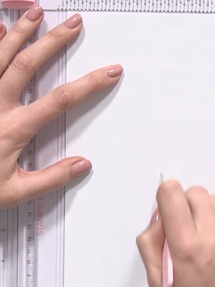 Step 6: Using your pen, mark a small square in the same position on the base paper as you did on the lid. Score along 