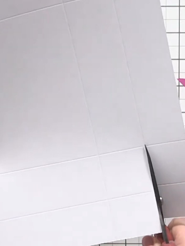 Step 9: Fold the sides of the lid box inward along the score lines. Tuck the flaps underneath to create the lid shape,