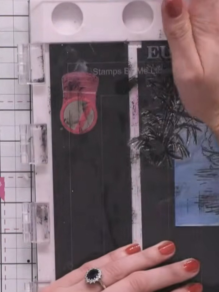 Step 7: Stamp additional foliage in green ink on the right side of the water area, moving the stamp slightly between i