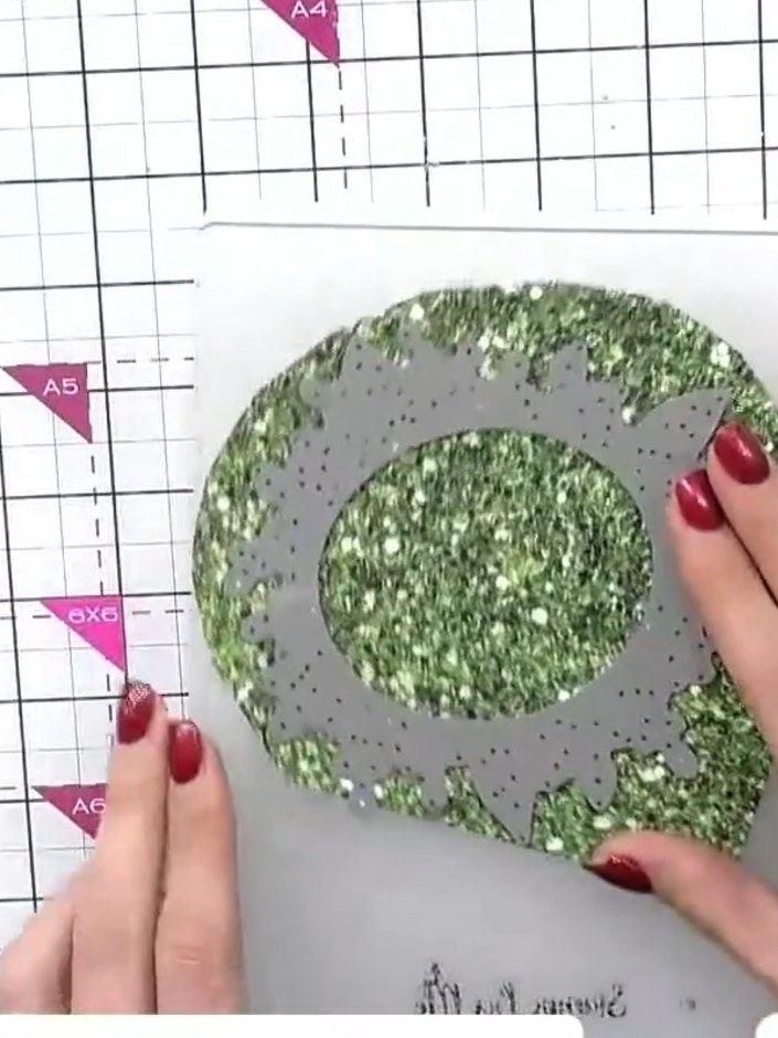 Step 2: Cut a second wreath die from green glitter card using the same die. This will create a contrasting wreath laye