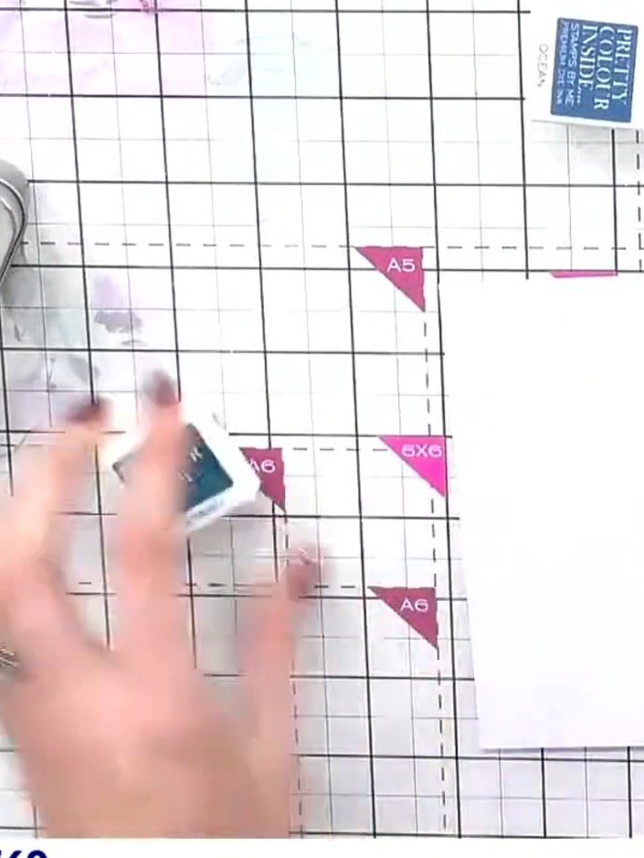 Step 1: Take your teal Distress Ink pad and swipe it diagonally across your white card base to begin creating the wate