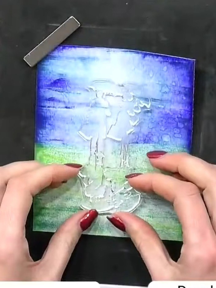 Step 10: Stamp the couple with umbrellas image a second time directly over the first stamping to create a solid black s