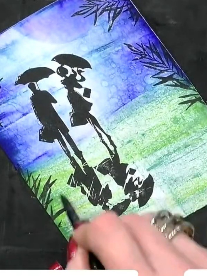 Step 15: Dry the card thoroughly with a heat gun to set the watercolour background and stamped design. Hold the heat gu