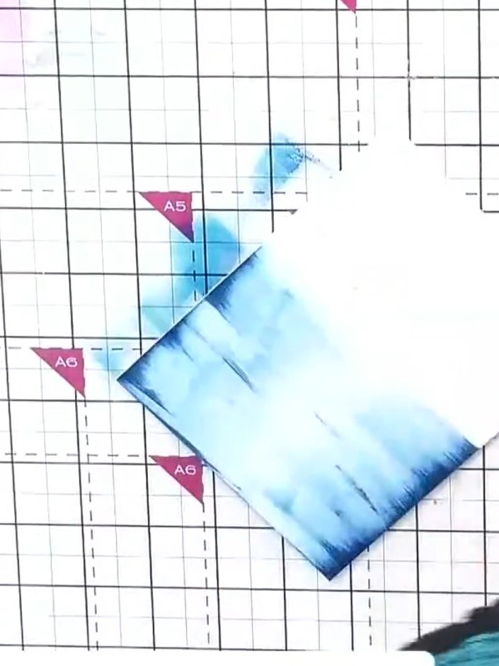 Step 2: Turn the card and swipe the blue ink pad across it in the opposite direction to build up the colour and create