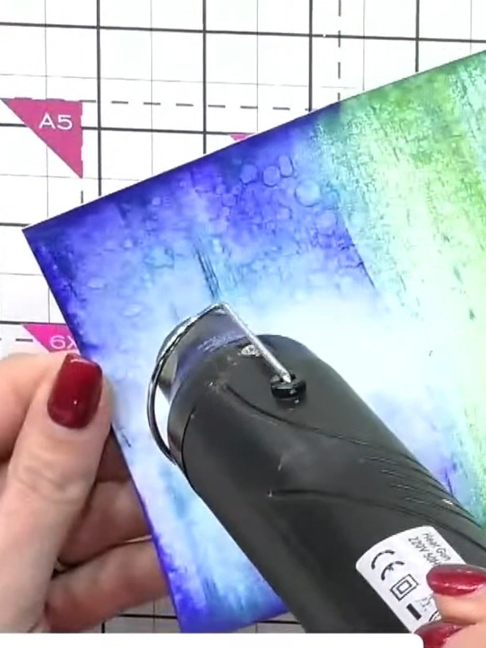 Step 7: Flick water droplets across the wet background using your fingers or a brush to create texture and interesting