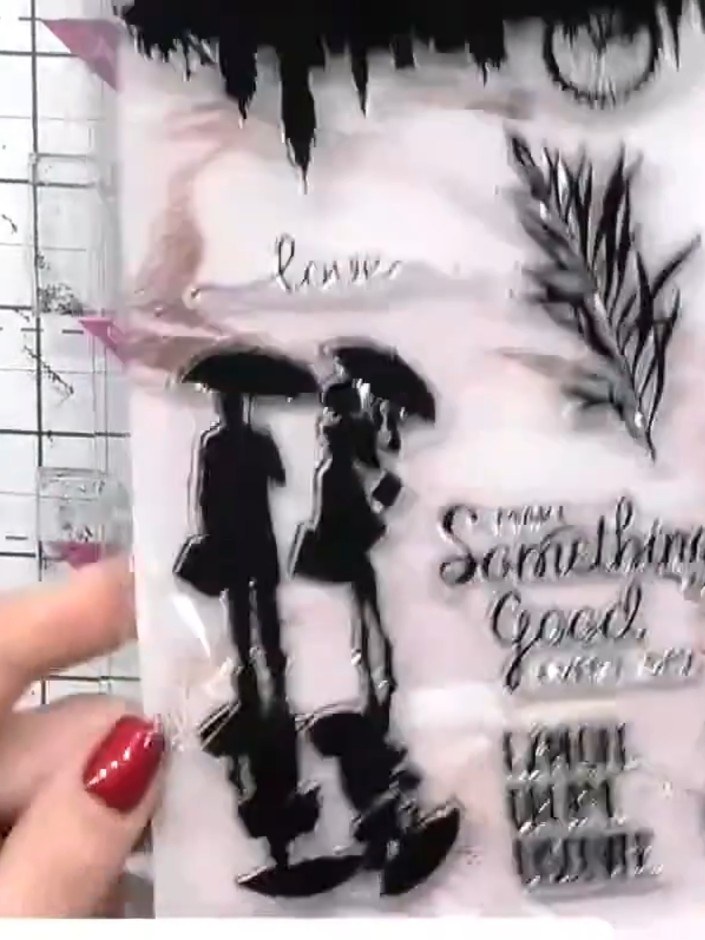 Step 9: Stamp the reflection-style figures in black ink onto the watercolour background, positioning them off to one s