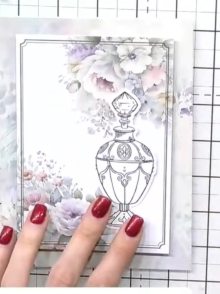 Step 5: Select flower embellishments from the ephemera pack. Choose purple and pink floral pieces to coordinate with y