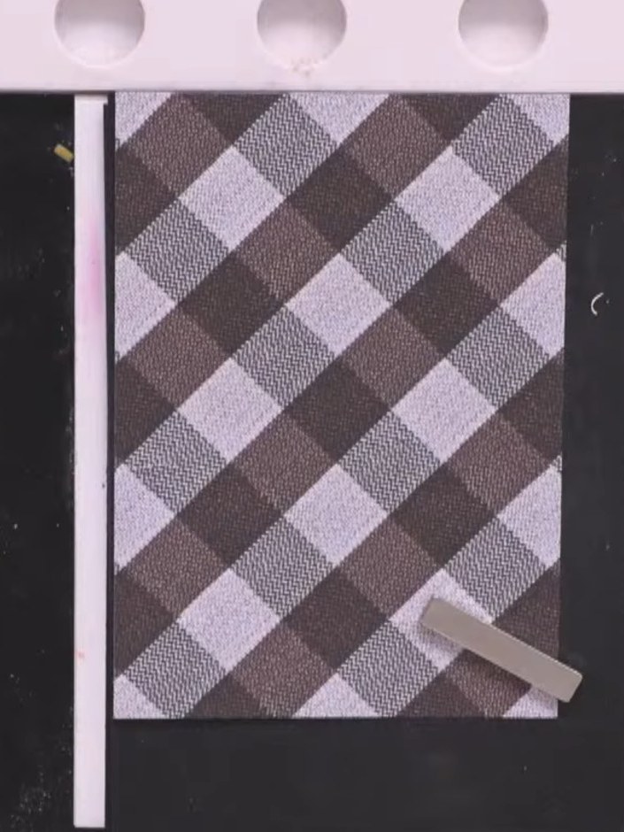 Step 8: Cut out the jacket and trousers sections from the patterned paper piece, carefully cutting around the hands to
