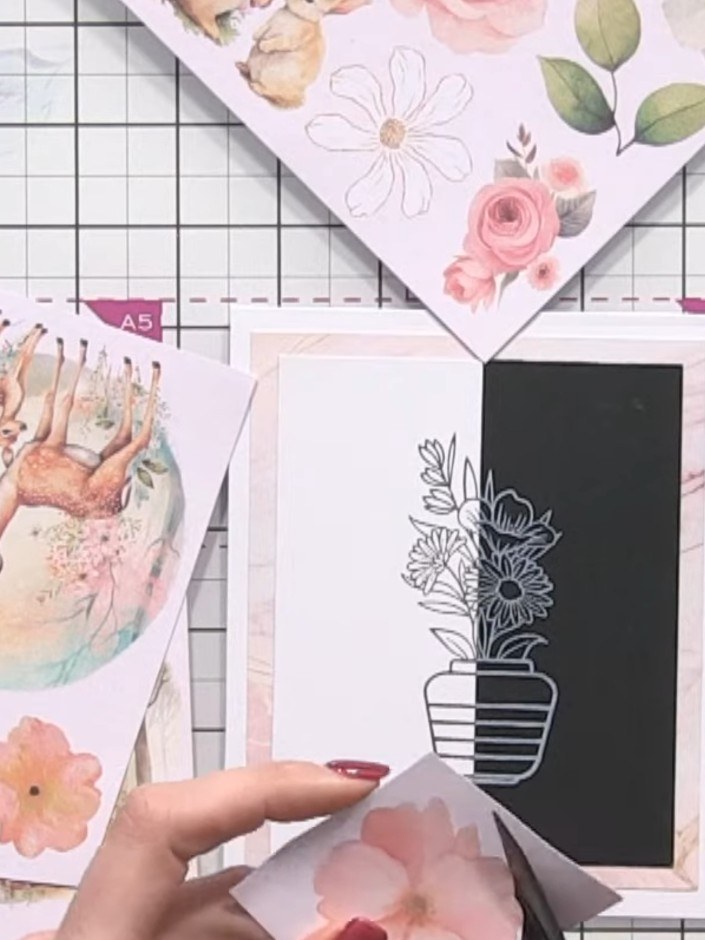 Step 10: Arrange and layer the cut-out flowers in a corner of the card. Use foam pads underneath the flowers to add dim
