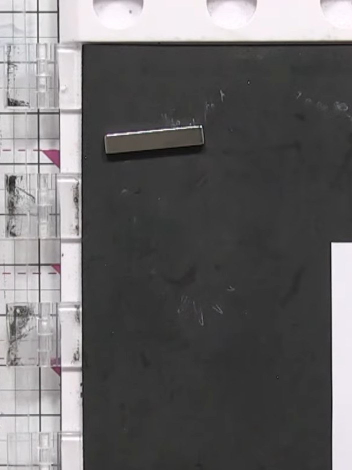 Step 2: Position the white card in the corner of your black stamp block. Press the black ink pad firmly onto the white