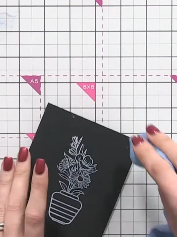 Step 5: Use a heat tool to set the white pigment ink on the black card. Hold the heat tool over the stamped image unti