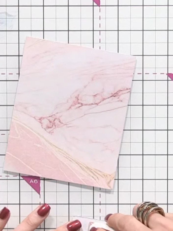 Step 8: Mount the pink marble pattern paper from the kit onto your card base. Position one piece on each side of the c