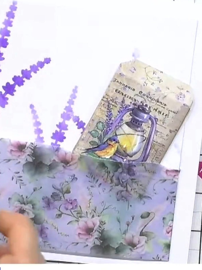 Step 5: Arrange the fussy-cut floral elements and decorative tag on the stencilled card front, positioning them to cre