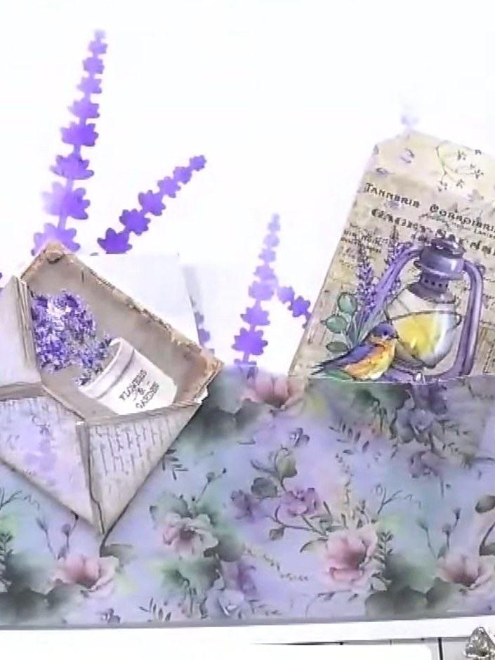 Step 6: Glue the ephemera pieces in place on one side of the card. Build up layers by positioning the envelope piece f