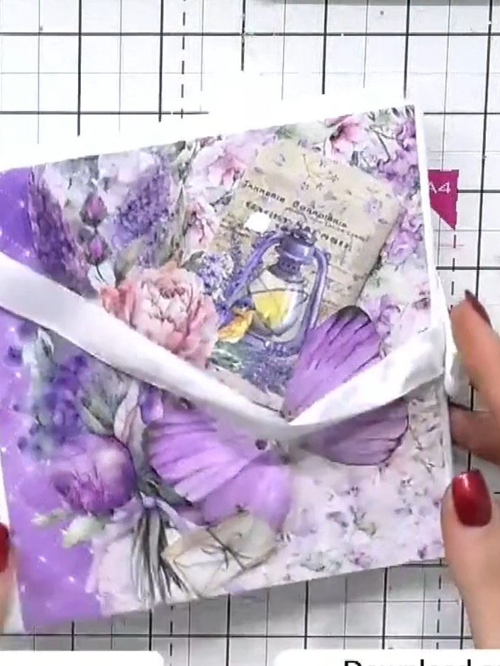 Step 3: Apply glue to the back of the purple butterfly patterned paper and adhere it to the front cover of the spiral-