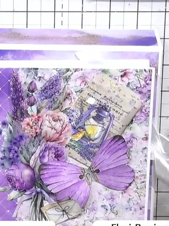 Step 4: Die-cut a butterfly from the decorative paper. Add dimension by attaching it to the album cover with foam pads