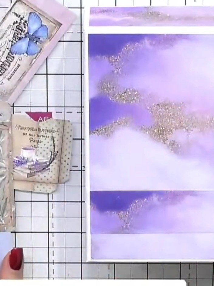 Step 6: Arrange and glue the die-cut butterfly and decorative mount elements onto the purple and silver glittered albu