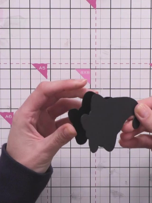 Step 5: Take the second black gnome silhouette piece and attach it on top of the first piece to create the freestandin