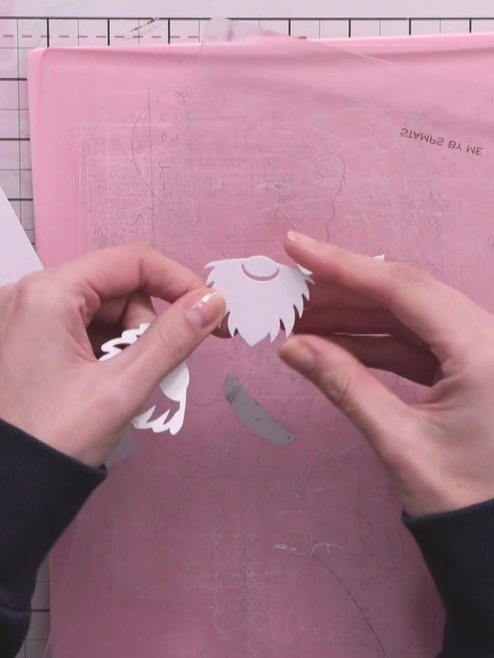 Step 7: Cut a strip of patterned or solid paper to create the gnome's hat belt. Position it across the hat area of you