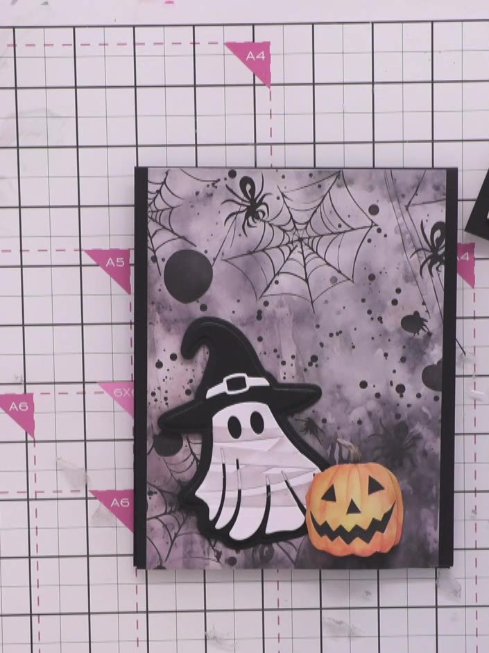 Step 13: Attach foam pads to the back of the wrapped ghost. Position the ghost over the banner on the card front, ensur