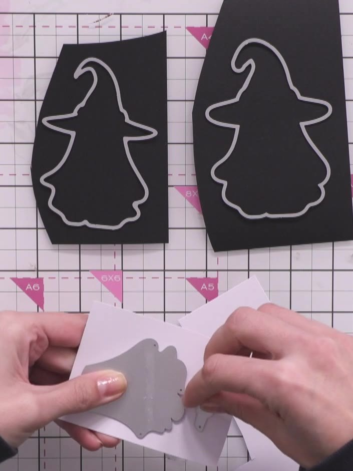 Step 3: Using the witch die, cut the ghost's main body from white card stock. The die cuts out the witch shape which w
