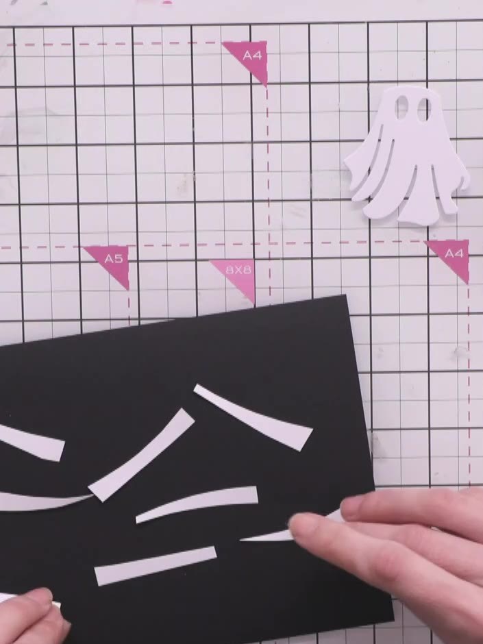 Step 6: Apply distress ink in grey to the edges of the white paper strips using a blending tool. Work the ink along al