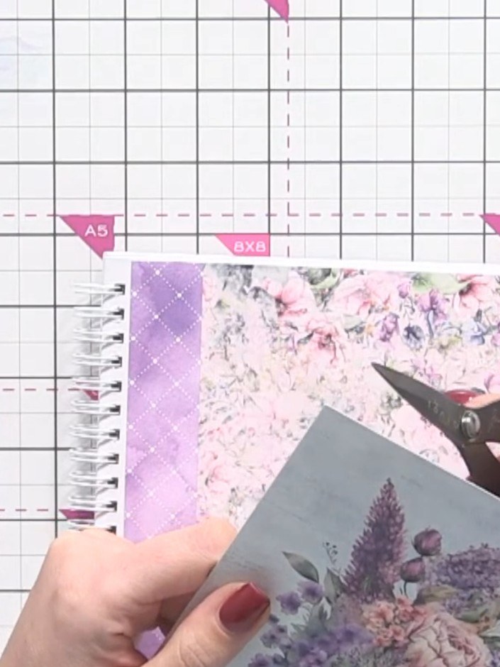 Step 2: Fussy-cut a floral bouquet design from the patterned paper using scissors, carefully cutting around the purple