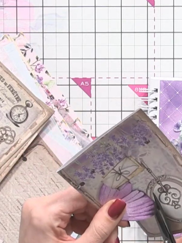 Step 5: Cut out a butterfly embellishment from the decorative paper and position it on the album cover to complement t