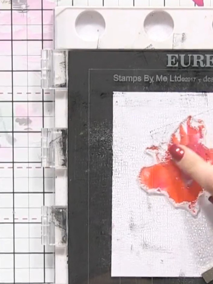 Step 3: Press the wet stamp firmly onto white card stock and hold it in place to allow the colours to blend and bleed 