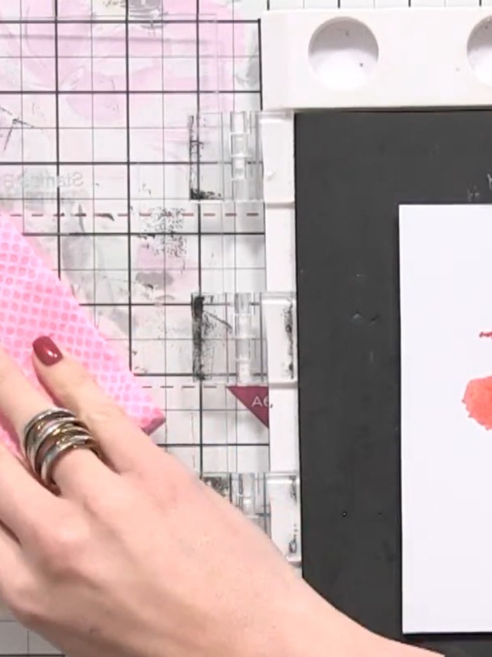Step 5: Clean the stamp thoroughly using a damp microfibre cloth, ensuring all pink and orange ink is completely remov